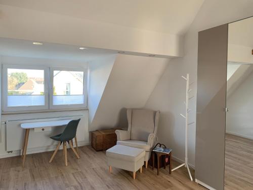City-Apartment Düsseldorf في دوسلدورف: غرفة معيشة مع كرسي ومكتب