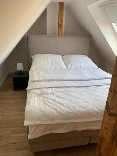 a bedroom with a white bed in a attic at City-Apartment Düsseldorf in Düsseldorf