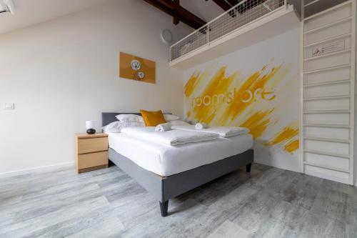 a bedroom with a bed and a painting on the wall at Roomstore Studio Apartments in Eger