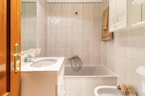 a bathroom with a sink and a bath tub at Rincón de Cantabria 1 in Santoña