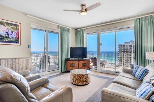 a living room with two couches and a television at Ariel Dunes I 1401 in Destin