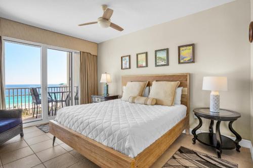 a bedroom with a bed with a view of the ocean at Ariel Dunes I 1401 in Destin