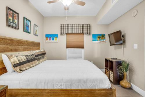 a bedroom with a large bed and a tv at Ariel Dunes I 1401 in Destin