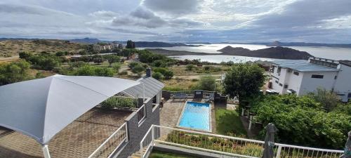 a view of a swimming pool and an umbrella at View Lodge in Gariep Dam