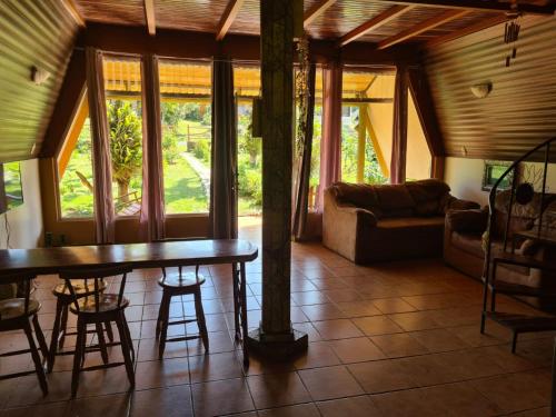 a living room with a table and a couch at Casa El Jardín in Piedras