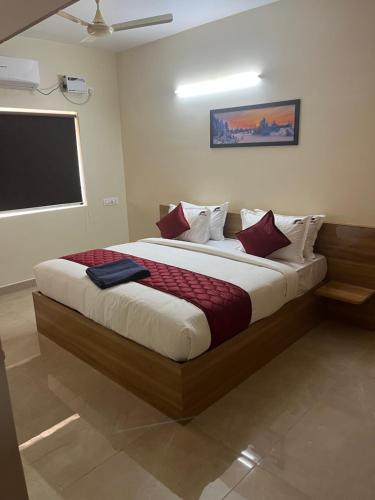 a bedroom with a large bed in a room at Chennai Airport Guest House in Chennai