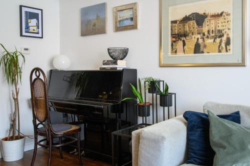 a living room with a piano and a couch at Designer Two-Bedroom Apartment in Split