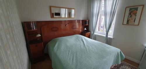 a bedroom with a bed with a white blanket on it at Maisonettewohnung in Elbnähe in Dresden