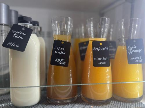a group of four different types of orange juice at Hotel Nafpaktos in Nafpaktos