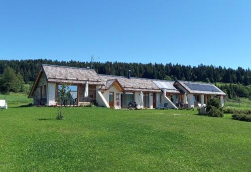 a house in a field with a large yard at AL SOGNO in Asiago