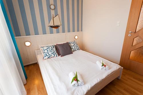 a bedroom with a bed with shoes on it at Apartament Słoneczny in Ustka