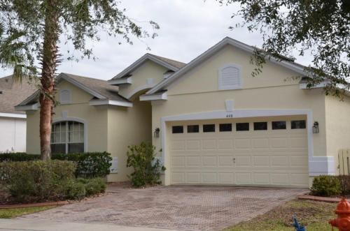 a white house with a garage at 4 Bed 3 Bath 448 Birkdale, overlooks golf course, home in Davenport