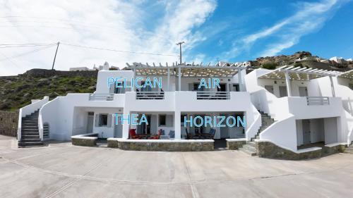 a white building with the words pelican art tea horacion at 1Path Thea Mykonos Super Paradise Beach House in Mýkonos City
