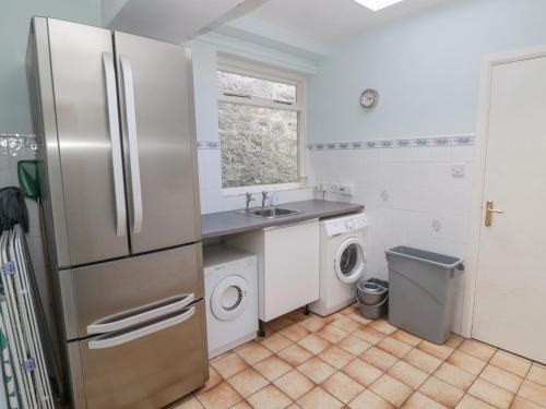 a kitchen with a refrigerator and a washer and dryer at Ravens Heugh in Morpeth