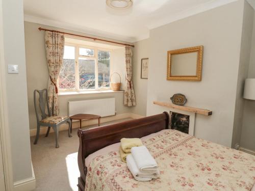 a bedroom with a bed and a window at Ravens Heugh in Morpeth