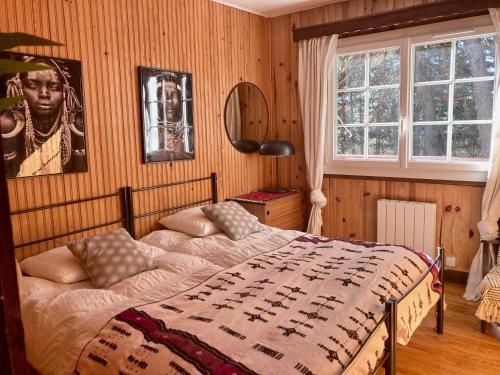 a bedroom with a bed with a blanket on it at Large Chalet Near Gorges du Verdon in La Bastide