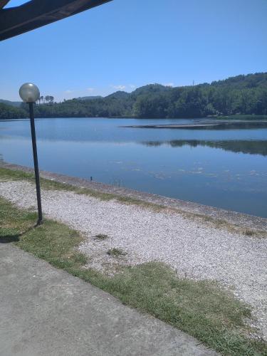 a view of a lake with a light pole at Villa Belvedere in Pieve Fosciana