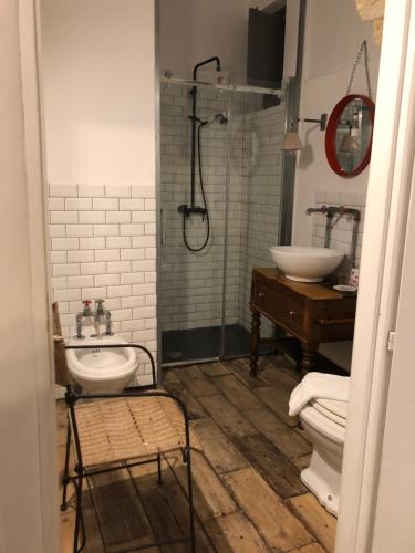 a bathroom with a sink and a toilet and a shower at La casa di Adele in Syracuse