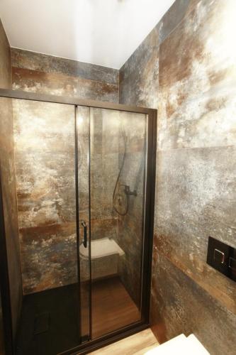 a shower with a glass door in a bathroom at Willa Park Międzyzdroje in Międzyzdroje