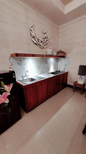 a kitchen with a sink and a counter top at Villa Padi Cangkringan in Yogyakarta