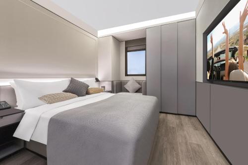 Postel nebo postele na pokoji v ubytování Citadines Xujiahui Shanghai