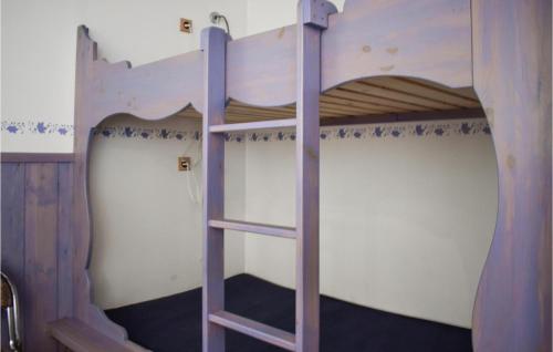 a bunk bed with a ladder in a room at Stunning Apartment In Nybro With Kitchen in Nybro