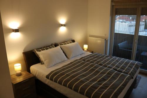 a bedroom with a bed with two lights on at Luxury apartment Anabella in Varaždin