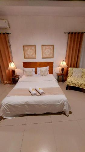 a bedroom with a large bed with two towels on it at Villa Padi Cangkringan in Yogyakarta