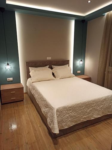 a bedroom with a large bed with two night stands at La Casa Delle Vacanze in Neos Marmaras