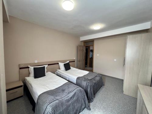 a hotel room with two beds in a room at Family Hotel Central in Shumen