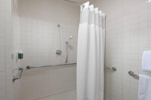 a shower with a shower curtain in a bathroom at Residence Inn Dallas Park Central in Dallas