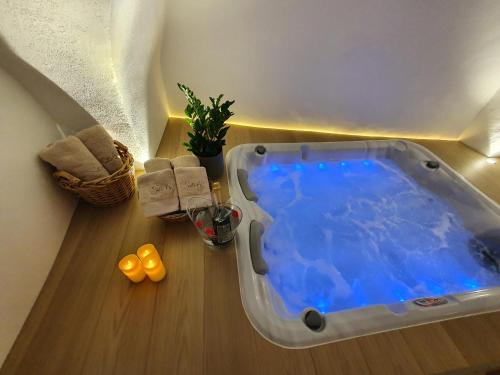 a bath tub with blue water in a room at Suite 6 in Nîmes