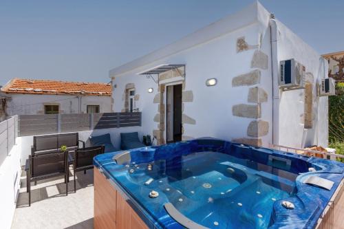 a hot tub in the middle of a patio at Avli Village Home with Outdoor Jacuzzi in Vafés