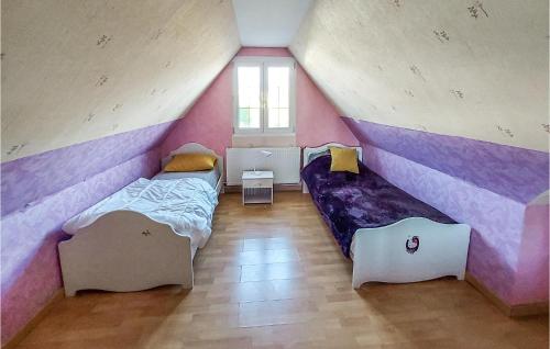 a bedroom with two beds in a attic at 4 Bedroom Nice Home In Marcoing 
