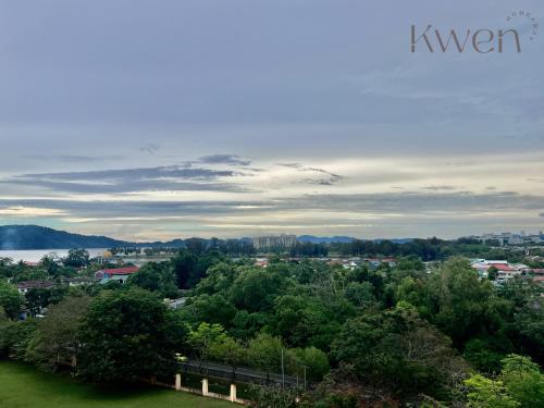 a view of a city from a hill with trees at KWEN Suites-Tanjung Aru InfinityPool Seaview/Airport View in Kota Kinabalu