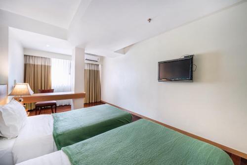 a hotel room with two beds and a flat screen tv at P2 Boutique in Bangkok