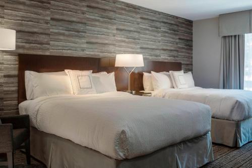 a hotel room with two beds and a window at Fairfield by Marriott Waterbury Stowe in Waterbury