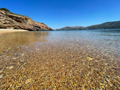 a large body of water with a rocky beach at The Velanidies - Οι Βελανιδιές in Agia Marina