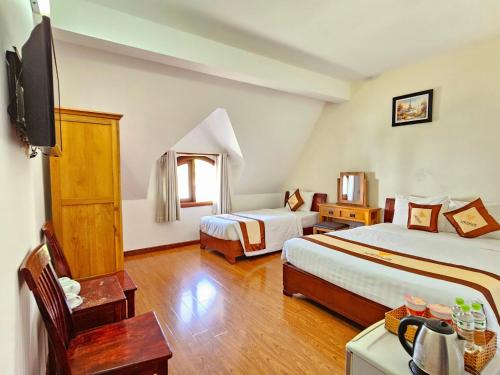 Una cama o camas en una habitación de Venus Phu Quoc Hotel