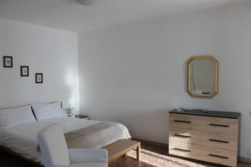 a bedroom with a bed and a dresser and a mirror at Casa Lia in Lesa