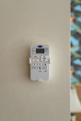a cell phone is hanging on a wall at P2 Boutique in Bangkok