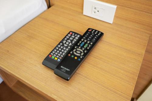 two remote controls sitting on top of a table at P2 Boutique in Bangkok