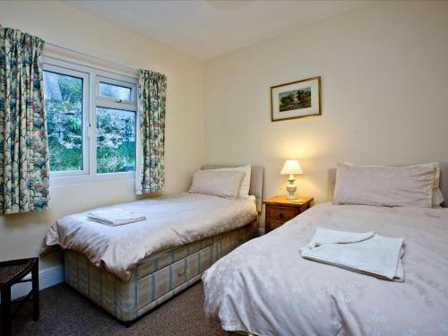 Кровать или кровати в номере River Cottage