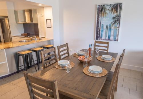 a dining room with a wooden table and chairs at Pavillions on 1770 in Agnes Water