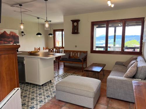 a kitchen and living room with a couch and a table at Casa rural en plena naturaleza Lic UVTR1524 in Eguíllor