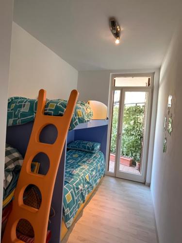 a bedroom with a bunk bed and a sliding door at Favola Bella The panoramic penthouse in Bardolino