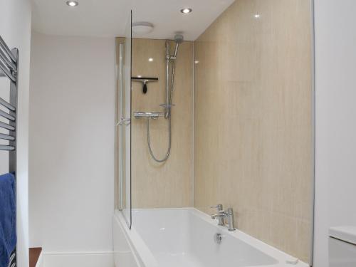 a bathroom with a shower and a white sink at The Mistress House in Hunstanton