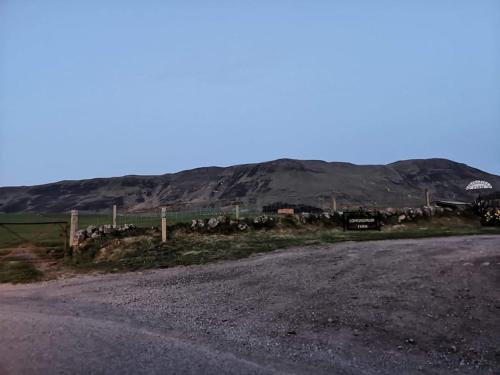 a road with a fence and a bunch of animals at Idyllic views over Loch Leven. Excellent location in Gateside