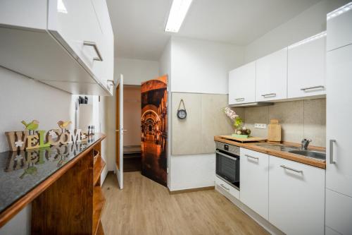 a kitchen with white cabinets and a refrigerator at Ferienwohnung Ginsterberg in Traben-Trarbach