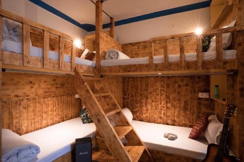 a room with a bunk bed with a ladder at Rainbow Hostelier in Leh